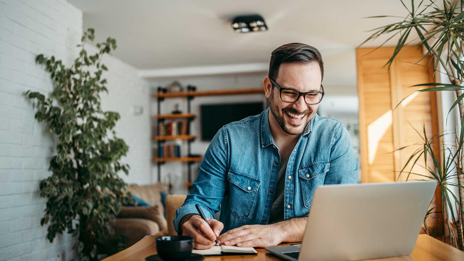 Man working at laptop and smiling