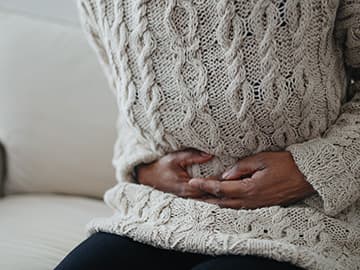 Woman holding stomach in pain