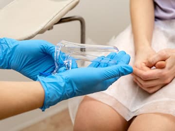 Nurse holding speculum