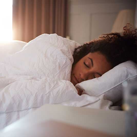 Lady sleeping comfortably in bed