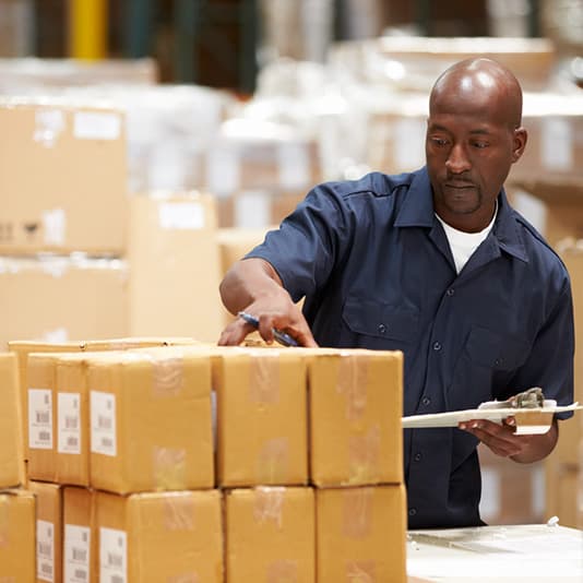 Man inspecting boxes in a factory