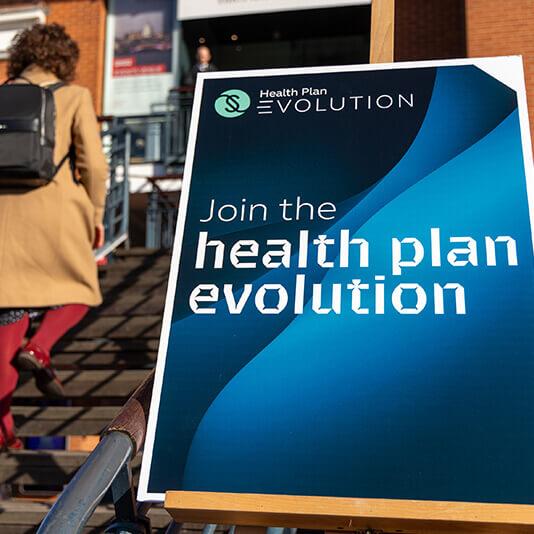 A sign reading 'Join the health plan evolution'