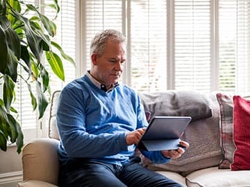 Man setting up a video call with a GP on his tablet