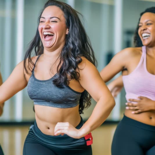 Two ladies enjoying a gym exercise class