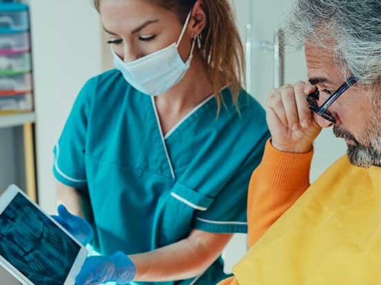 Dentist showing x-ray to patient