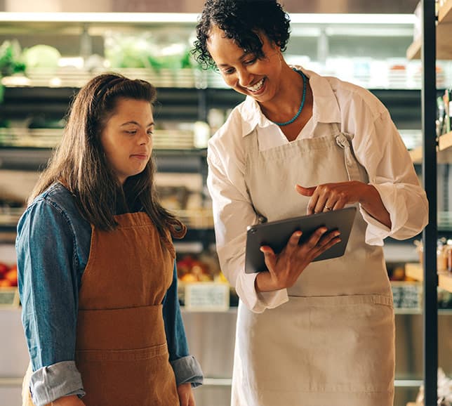 Shop workers talking while looking at tablet